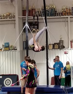 patrick billette competes on the rings in a special olympics gymnastics event.